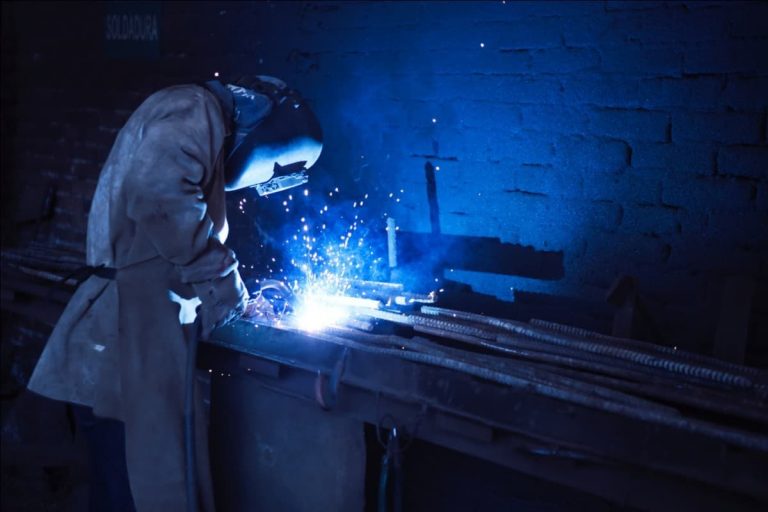 A man in helmet welding metals