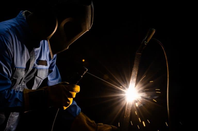 A welder using a welding stick.